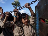 Students are huddling together in a truck to going school in Tugu Utara Village, Regency Bogor, West Java province, Indonesia on 2 June, 202...