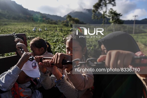 Students are huddling together in a truck to going school in Tugu Utara Village, Regency Bogor, West Java province, Indonesia on 2 June, 202...