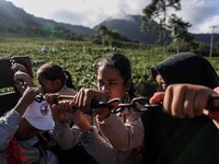 Students are huddling together in a truck to going school in Tugu Utara Village, Regency Bogor, West Java province, Indonesia on 2 June, 202...