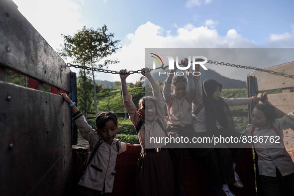 Students are huddling together in a truck to going school in Tugu Utara Village, Regency Bogor, West Java province, Indonesia on 2 June, 202...