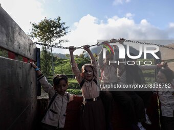 Students are huddling together in a truck to going school in Tugu Utara Village, Regency Bogor, West Java province, Indonesia on 2 June, 202...