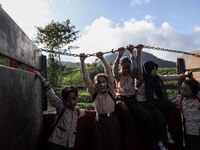 Students are huddling together in a truck to going school in Tugu Utara Village, Regency Bogor, West Java province, Indonesia on 2 June, 202...