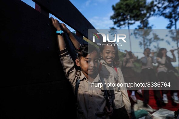 Students are huddling together in a truck to going school in Tugu Utara Village, Regency Bogor, West Java province, Indonesia on 2 June, 202...