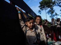 Students are huddling together in a truck to going school in Tugu Utara Village, Regency Bogor, West Java province, Indonesia on 2 June, 202...