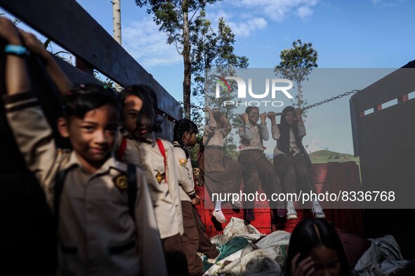 Students are huddling together in a truck to going school in Tugu Utara Village, Regency Bogor, West Java province, Indonesia on 2 June, 202...