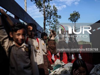 Students are huddling together in a truck to going school in Tugu Utara Village, Regency Bogor, West Java province, Indonesia on 2 June, 202...