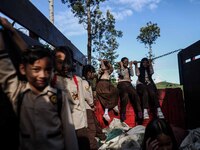 Students are huddling together in a truck to going school in Tugu Utara Village, Regency Bogor, West Java province, Indonesia on 2 June, 202...