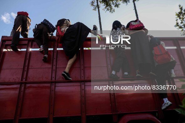 Students are huddling together in a truck to going school in Tugu Utara Village, Regency Bogor, West Java province, Indonesia on 2 June, 202...