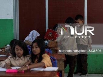 A teacher is seen teaching students at a school in Tugu Utara Village, Regency Bogor, West Java province, Indonesia on 2 June, 2022. (