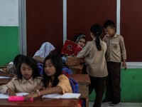 A teacher is seen teaching students at a school in Tugu Utara Village, Regency Bogor, West Java province, Indonesia on 2 June, 2022. (