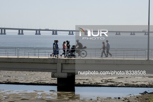 A group of people are seen performing outdoor activities in the surroundings of the Vasco da Gama walkway, close to the Tejo river. Lisbon,...