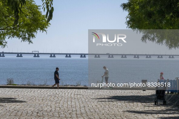 A group of people are seen performing outdoor activities in the surroundings of the Vasco da Gama walkway, close to the Tejo river. Lisbon,...