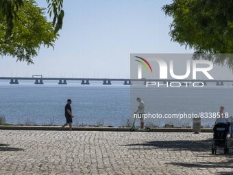 A group of people are seen performing outdoor activities in the surroundings of the Vasco da Gama walkway, close to the Tejo river. Lisbon,...