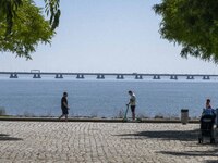 A group of people are seen performing outdoor activities in the surroundings of the Vasco da Gama walkway, close to the Tejo river. Lisbon,...