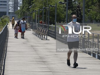 A group of people are seen performing outdoor activities in the surroundings of the Vasco da Gama walkway, close to the Tejo river. Lisbon,...