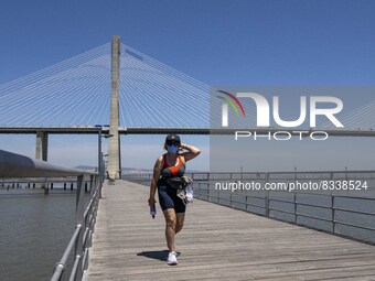 A woman wearing protective mask  performs outdoor activities in the surroundings of the Vasco da Gama walkway, close to the Tejo river. Lisb...