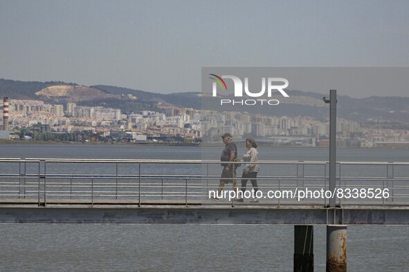 A group of people are seen performing outdoor activities in the surroundings of the Vasco da Gama walkway, close to the Tejo river. Lisbon,...