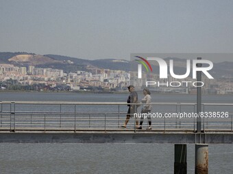 A group of people are seen performing outdoor activities in the surroundings of the Vasco da Gama walkway, close to the Tejo river. Lisbon,...