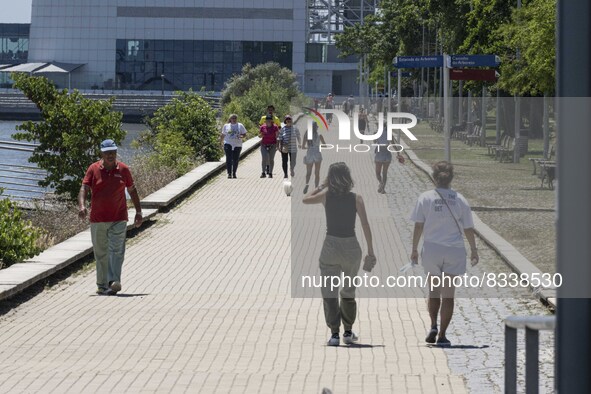 A group of people are seen performing outdoor activities in the surroundings of the Vasco da Gama walkway, close to the Tejo river. Lisbon,...