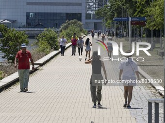 A group of people are seen performing outdoor activities in the surroundings of the Vasco da Gama walkway, close to the Tejo river. Lisbon,...