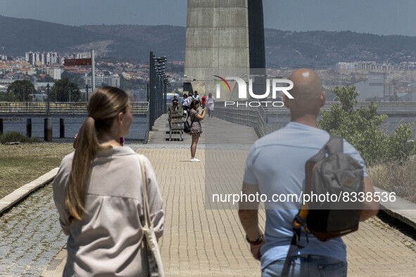 A group of people are seen performing outdoor activities in the surroundings of the Vasco da Gama walkway, close to the Tejo river. Lisbon,...