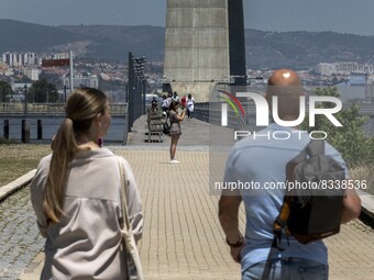 A group of people are seen performing outdoor activities in the surroundings of the Vasco da Gama walkway, close to the Tejo river. Lisbon,...