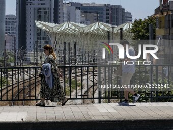 A group of people are seen performing outdoor activities in the surroundings of the Vasco da Gama walkway, close to the Tejo river. Lisbon,...