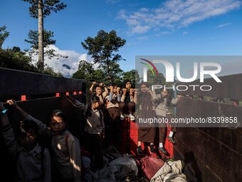 Students are huddling together in a truck to going school in Tugu Utara Village, Regency Bogor, West Java province, Indonesia on 2 June, 202...