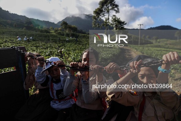 Students are huddling together in a truck to going school in Tugu Utara Village, Regency Bogor, West Java province, Indonesia on 2 June, 202...