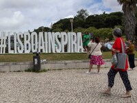 People are seen taking pictures in a tourist advertisement in the surroundings of the Marquez de Pombal monument. Lisbon, June 03, 2022. Por...