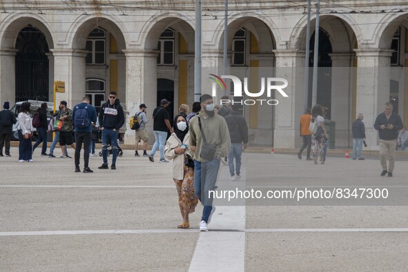 People wearing protective masks are seen walking near Praça de Comercio. Lisbon, June 03, 2022. Portugal has already passed the peak of this...