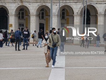 People wearing protective masks are seen walking near Praça de Comercio. Lisbon, June 03, 2022. Portugal has already passed the peak of this...