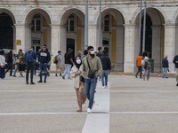 People wearing protective masks are seen walking near Praça de Comercio. Lisbon, June 03, 2022. Portugal has already passed the peak of this...