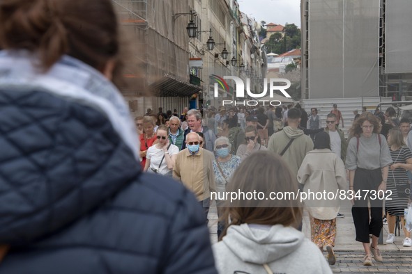 People wearing protective masks are seen walking near Praça de Comercio. Lisbon, June 03, 2022. Portugal has already passed the peak of this...