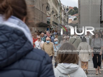 People wearing protective masks are seen walking near Praça de Comercio. Lisbon, June 03, 2022. Portugal has already passed the peak of this...