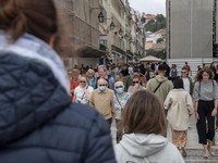 People wearing protective masks are seen walking near Praça de Comercio. Lisbon, June 03, 2022. Portugal has already passed the peak of this...