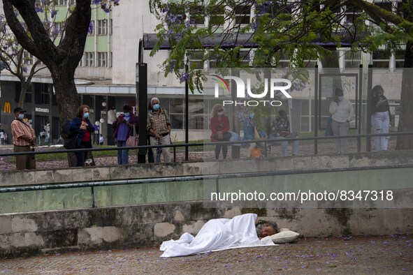 A person is seen sleeping near a bus station located near the gardens of Eduardo VII. Lisbon, June 03, 2022. Portugal has already passed the...