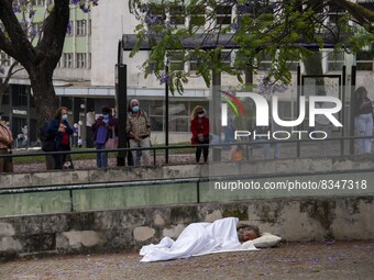 A person is seen sleeping near a bus station located near the gardens of Eduardo VII. Lisbon, June 03, 2022. Portugal has already passed the...