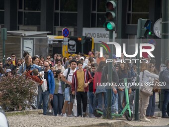 A group of people is seen walking along a nearby avenue that crosses the vicinity of Eduardo VII Gardens. Lisbon, June 03, 2022. Portugal ha...