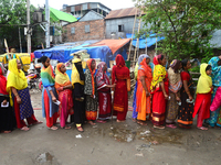 Slum dwellers wait to receive a Booster Dose of COVID-19 vaccine at a makeshift vaccination center during a national campaign at Karail Slum...