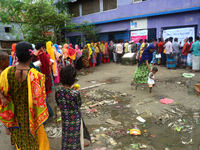 Slum dwellers wait to receive a Booster Dose of COVID-19 vaccine at a makeshift vaccination center during a national campaign at Karail Slum...