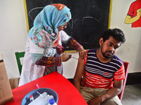 Slum dweller receives a Booster Dose of COVID-19 vaccine at a makeshift vaccination center during a national campaign at Karail Slum in Dhak...