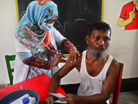 Slum dweller receives a Booster Dose of COVID-19 vaccine at a makeshift vaccination center during a national campaign at Karail Slum in Dhak...