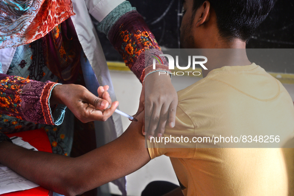 Slum dweller receives a Booster Dose of COVID-19 vaccine at a makeshift vaccination center during a national campaign at Karail Slum in Dhak...