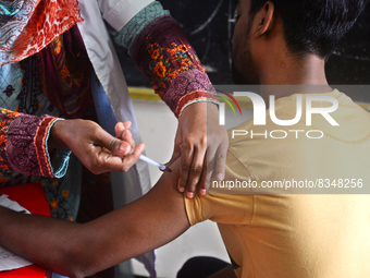 Slum dweller receives a Booster Dose of COVID-19 vaccine at a makeshift vaccination center during a national campaign at Karail Slum in Dhak...