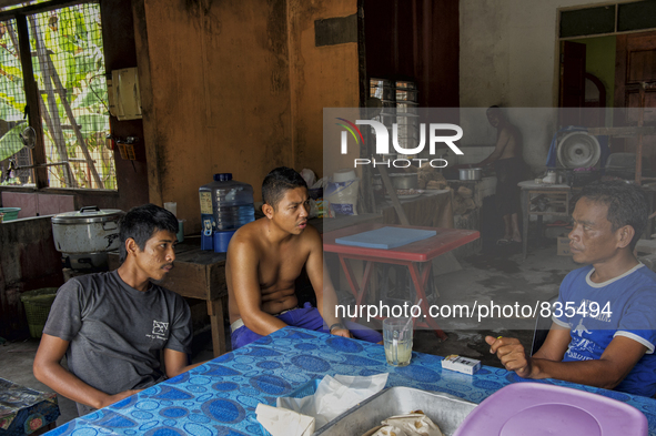 Male workers are drinking a beverage and resting at a small mamak  / Kampung Keluat, Kelantan / Malaysia. *360 hours of waiting. 50 Cent's h...