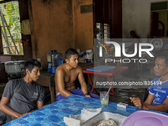 Male workers are drinking a beverage and resting at a small mamak  / Kampung Keluat, Kelantan / Malaysia. *360 hours of waiting. 50 Cent's h...