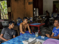 Male workers are drinking a beverage and resting at a small mamak  / Kampung Keluat, Kelantan / Malaysia. *360 hours of waiting. 50 Cent's h...