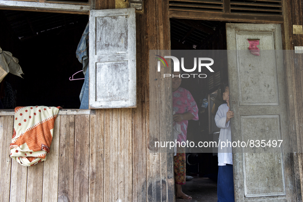 Female worker and her daughter are looking and smiling each other at their house / Kampung Keluat, Kelantan / Malaysia. *360 hours of waitin...