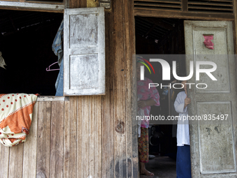 Female worker and her daughter are looking and smiling each other at their house / Kampung Keluat, Kelantan / Malaysia. *360 hours of waitin...